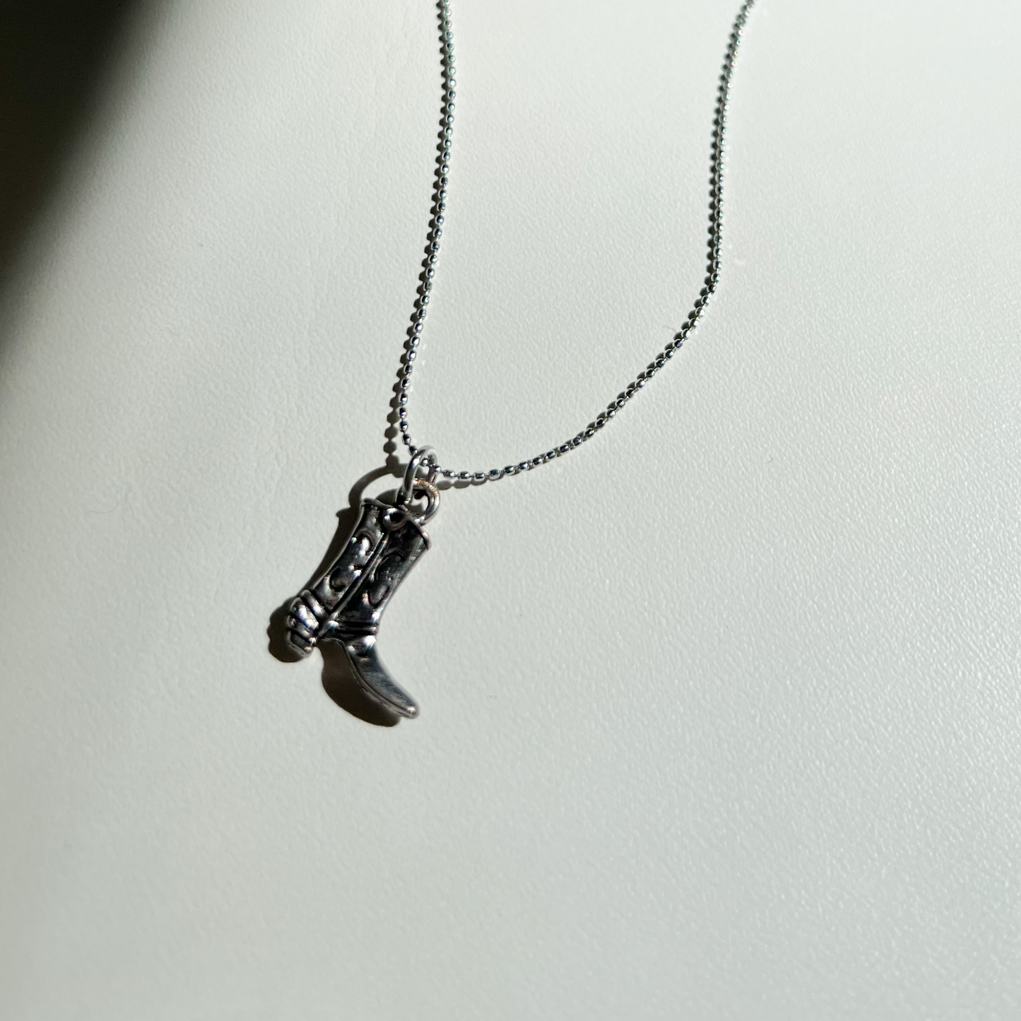Roop Jewelry cowboy boot necklace. Sustainable and ethical jewelry in Oakland, ca.