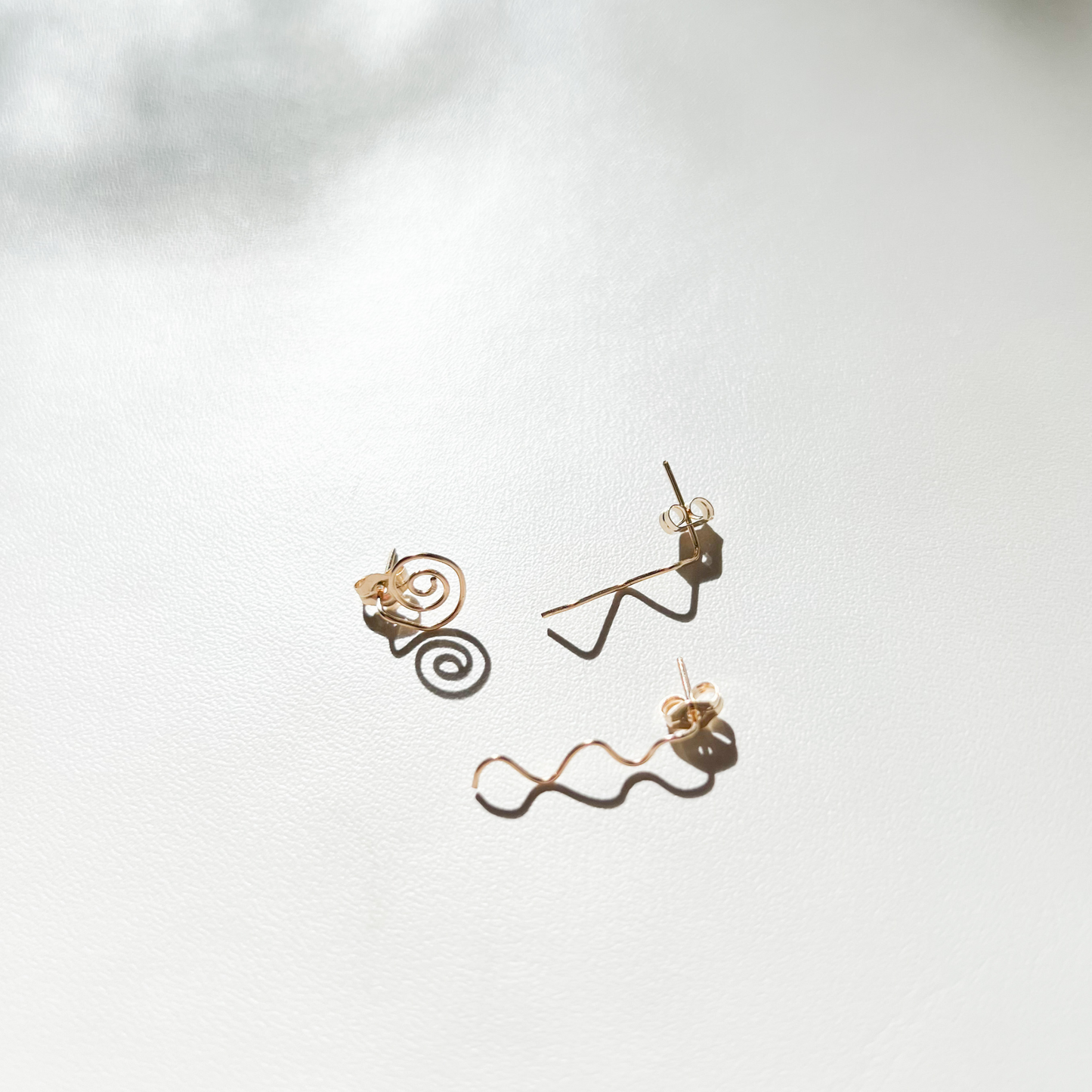 Roop Jewelry mix and match studs. Gold filled wire studs. Spiral studs. Squiggle studs. Zigzag studs. Spring 2022 fashion trends. Summer 2022 fashion trends. 