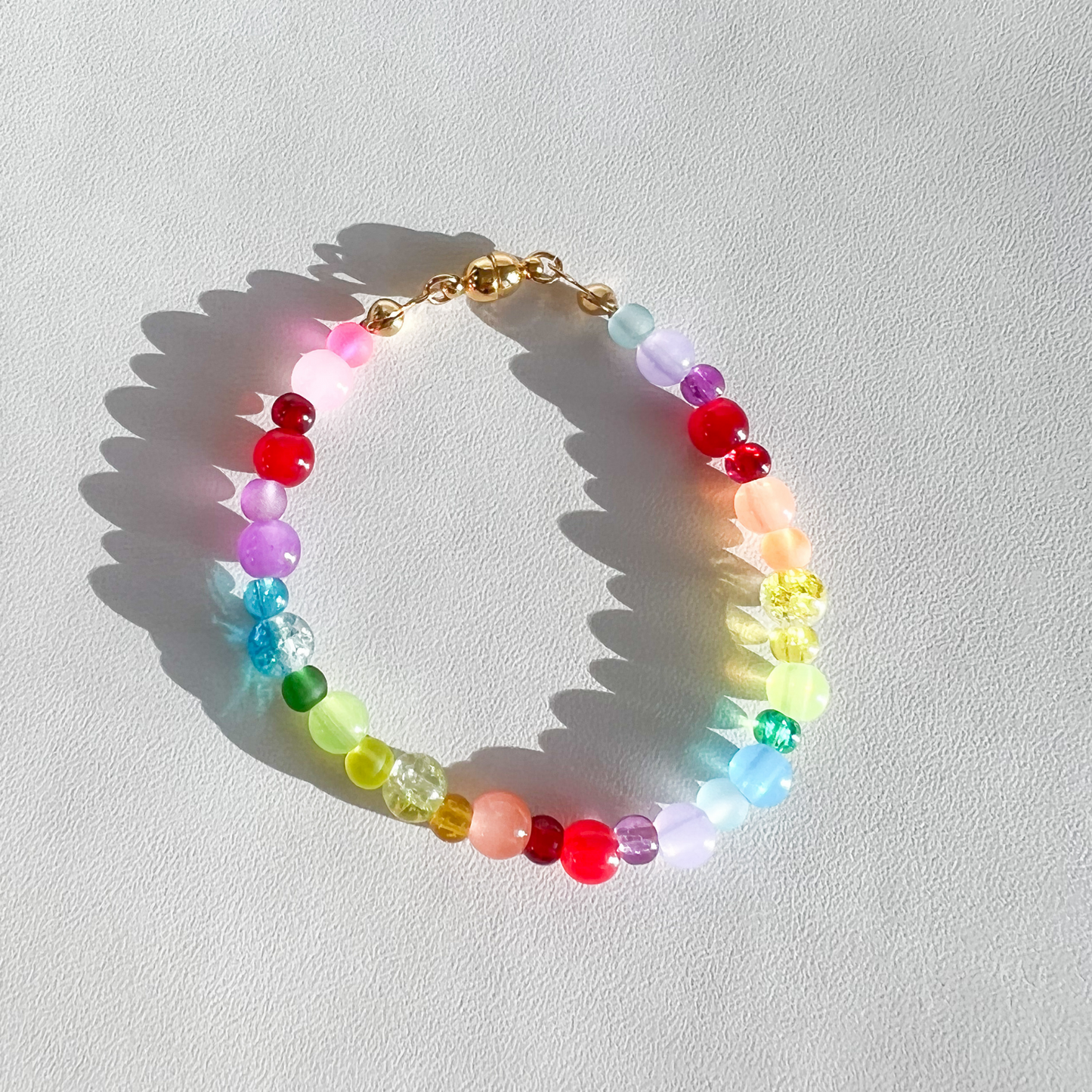 Roop Jewelry rainbow glass bracelet. Colorful kindergarten core bracelet. Rainbow aesthetic. Spring 2022 aesthetic. Summer 2022 aesthetic. Summer 2022 fashion trends. Summer 2022 outfits.